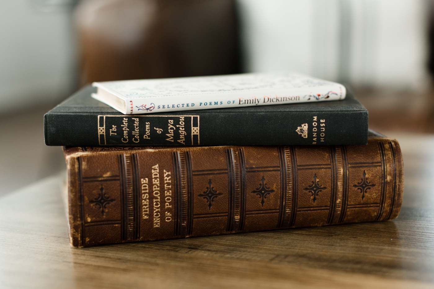 Old, hardcover poetry books stacked on top of each other